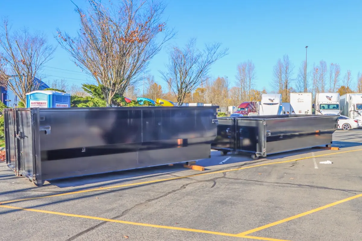 Professional dumpster rental service with roll-off container on residential driveway in Crawfordville